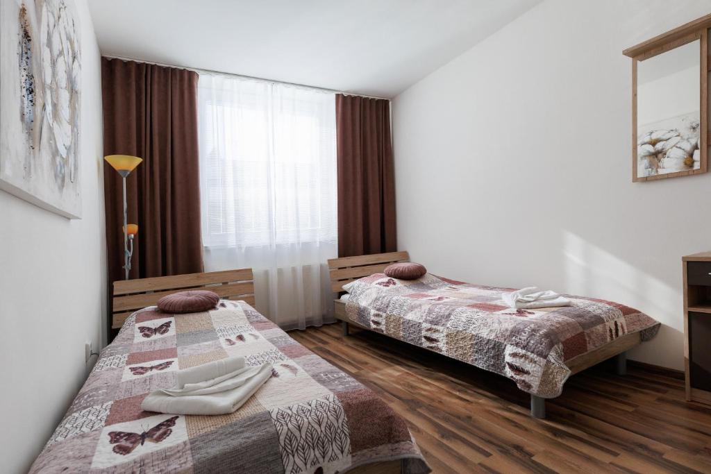Postel nebo postele na pokoji v ubytování Agro Complex Apartments