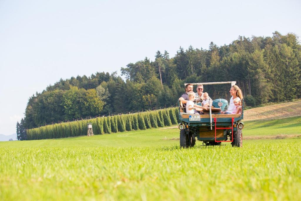 a group of people riding in a cart in a field at Ferienhof Egger in Tettnang