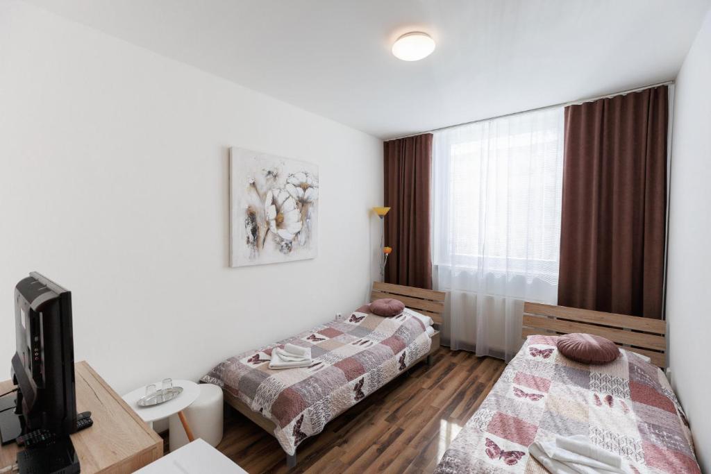 Postel nebo postele na pokoji v ubytování Agro Complex Apartments