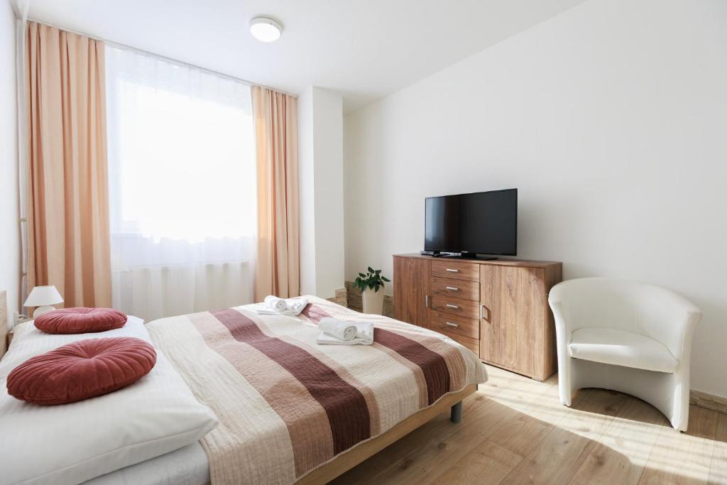 Postel nebo postele na pokoji v ubytování Agro Complex Apartments