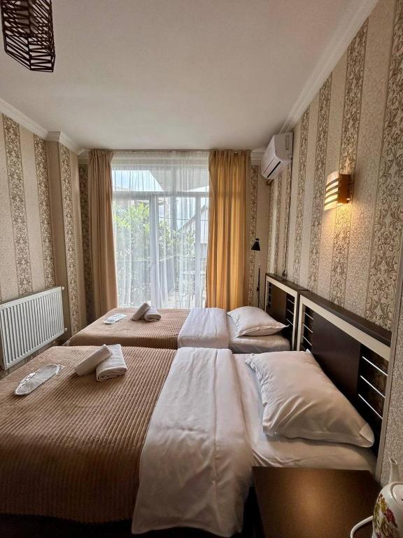 Postel nebo postele na pokoji v ubytování Hotel Marioni