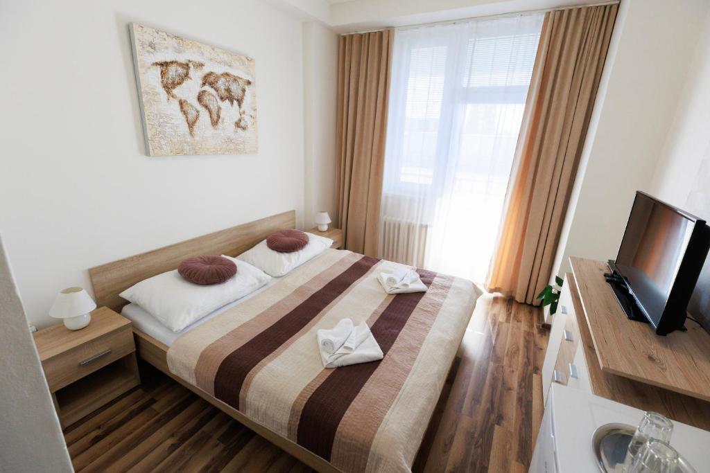 Postel nebo postele na pokoji v ubytování Agro Complex Apartments