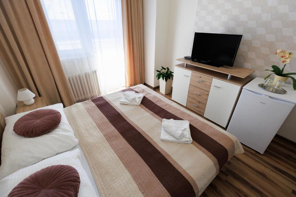 Postel nebo postele na pokoji v ubytování Agro Complex Apartments