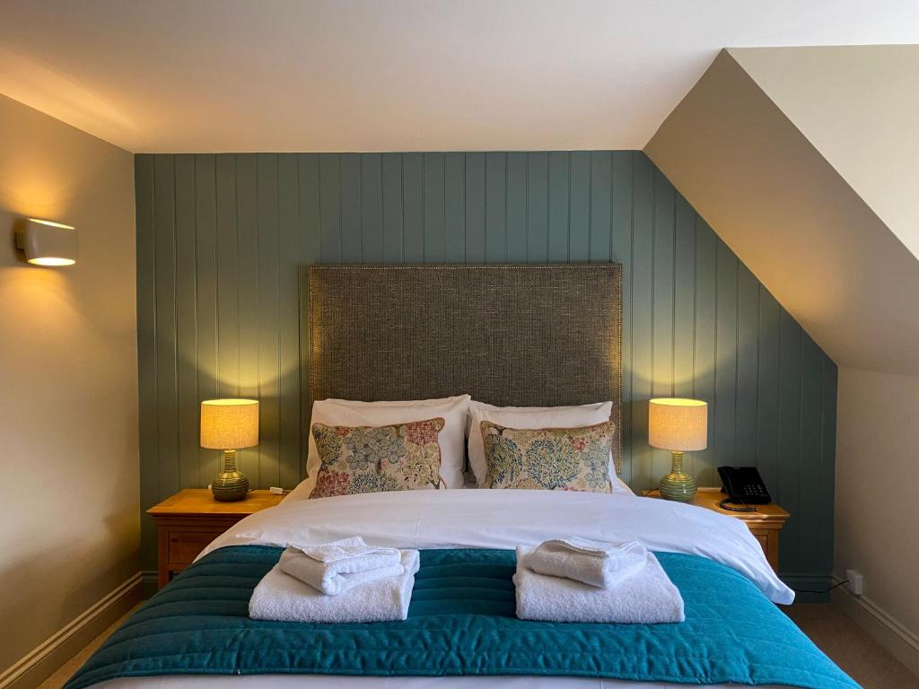 a bedroom with a large bed with two lamps at Caley in Hunstanton