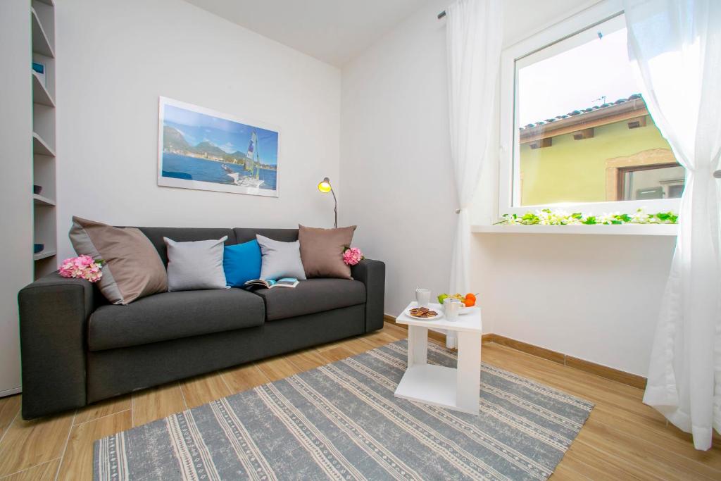 a living room with a couch and a window at Nido sui Tetti di Riva del Garda in Riva del Garda