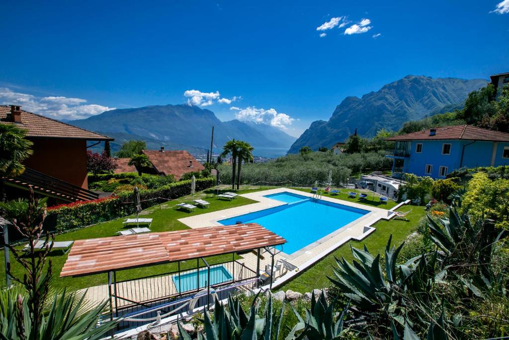 an aerial view of a villa with a swimming pool and mountains at Residence Christina Due Laghi in Tenno