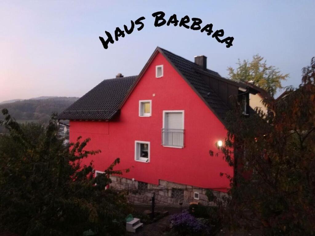 a red house with a sign that says kings barnestead at Haus Barbara Modern retreat in Bad Brückenau