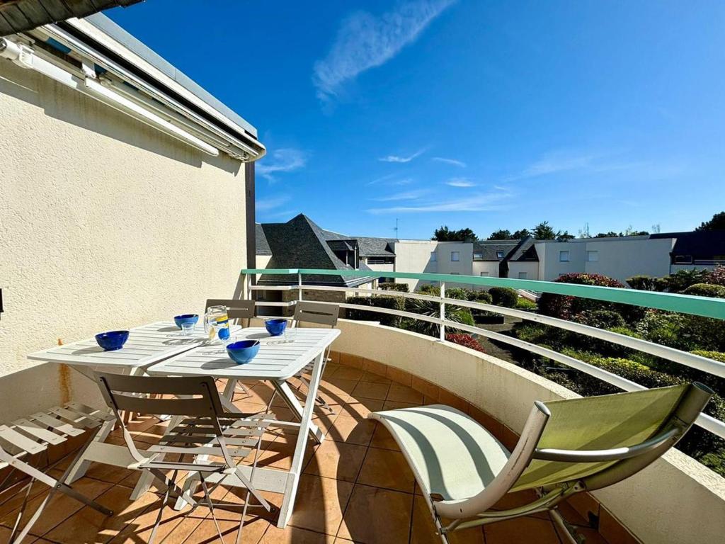 un patio avec une table et des chaises sur un balcon dans l'établissement Appartement T2+Cabine à Carnac, Balcon Sud, Proche Plages, 4 Pers. - FR-1-377-29, à Carnac