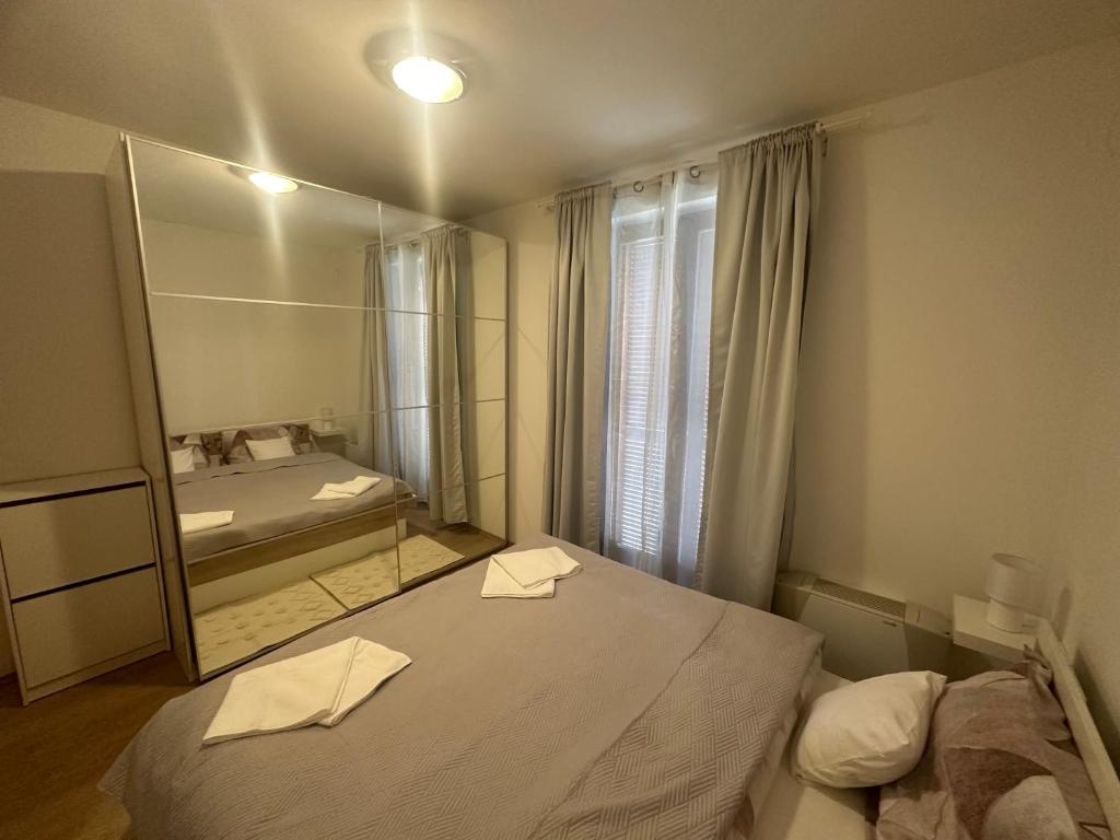 a bedroom with a large mirror and a bed at DunaVera Apartman in Budapest
