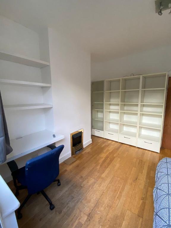 a room with shelves and a desk and a chair at [ Mushroom Room ] Double bedroom in NW in Hendon