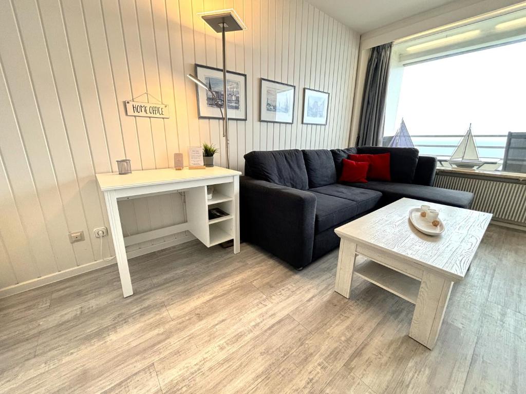 a living room with a couch and a table at Ferienpark Sierksdorf App 321 - Strandlage in Sierksdorf