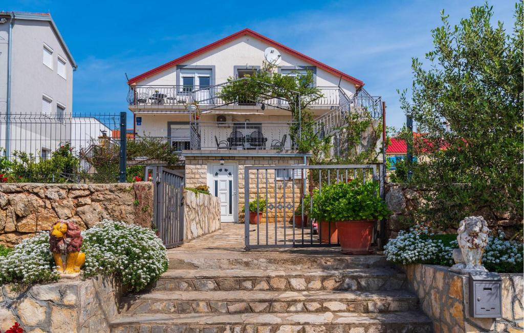 a house with stairs in front of it at Amazing Apartment In Maslenica in Maslenica