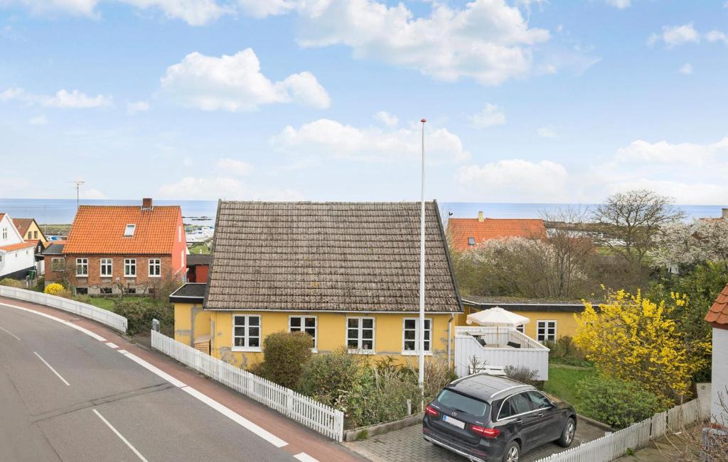 a yellow house on the side of a road at 2 Bedroom Pet Friendly Home In Svaneke in Svaneke
