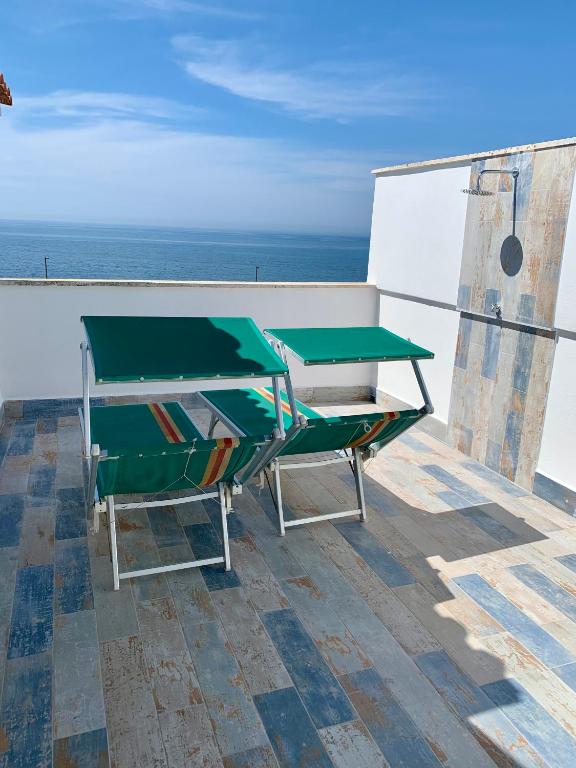 a ping pong table on the roof of a house at Sunset Apartment in Santa Marinella