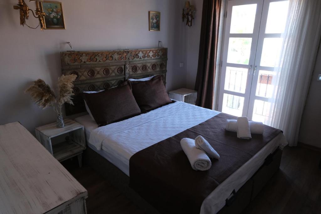 Postel nebo postele na pokoji v ubytování Rikas Boutique Otel