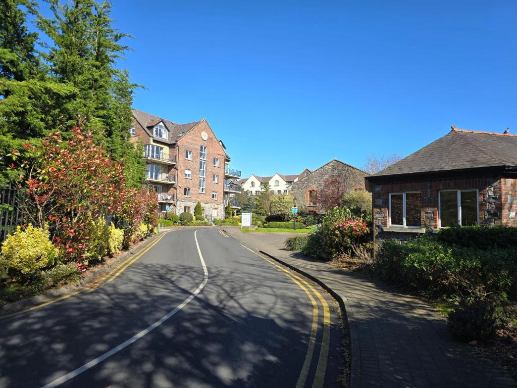 an empty street in a residential neighborhood with houses at Gracian OMB Dublin Apartment in Dublin