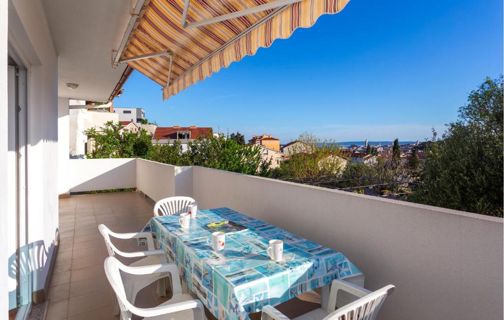 a table and chairs on the balcony of a house at 2 Bedroom Stunning Apartment In Rab in Rab