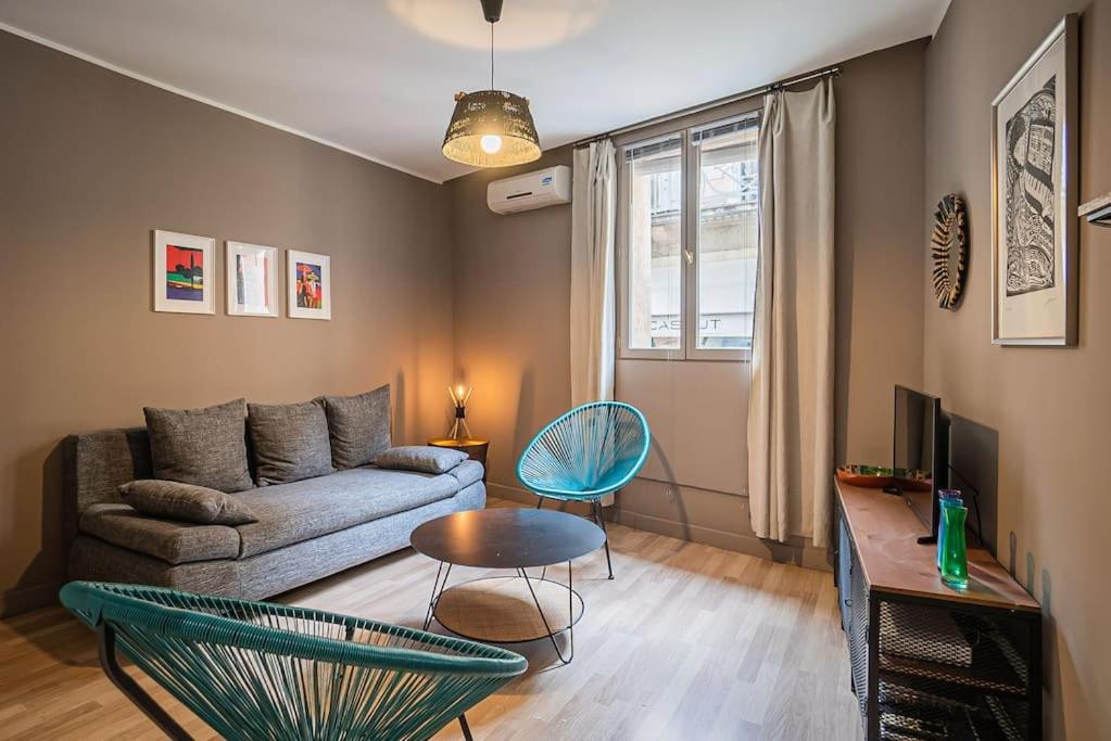un salon avec un canapé et une table dans l'établissement L'Acapulco, Charmant T1, Clim, Place Comédie, à Montpellier