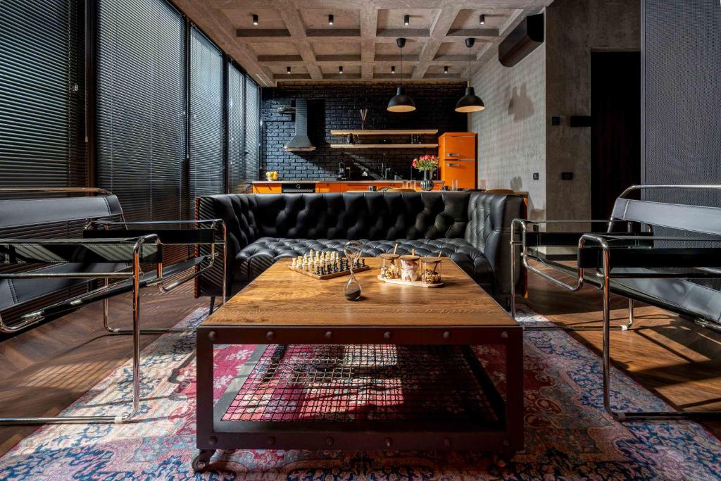 a living room with a couch and a coffee table at Win Herastrau - Luxury Design 2BR Apartment - Parking in Bucharest