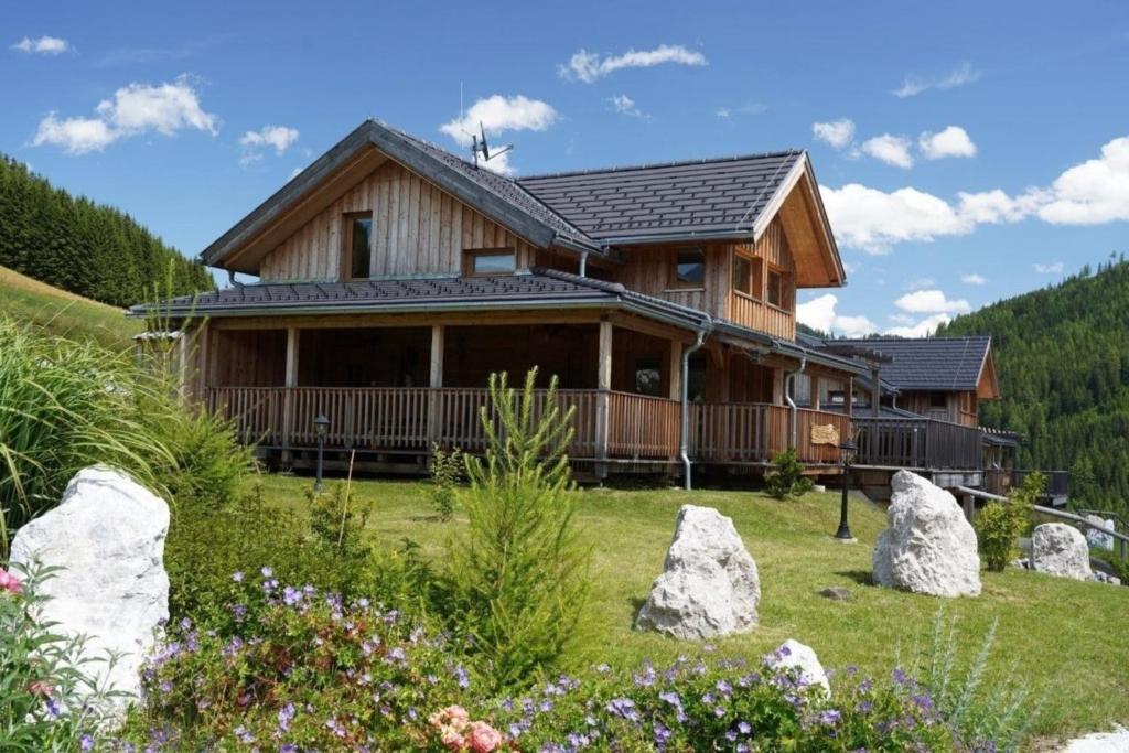 a log cabin in the mountains with rocks at Luxus Chalet Murmeltierhütte in Hohentauern