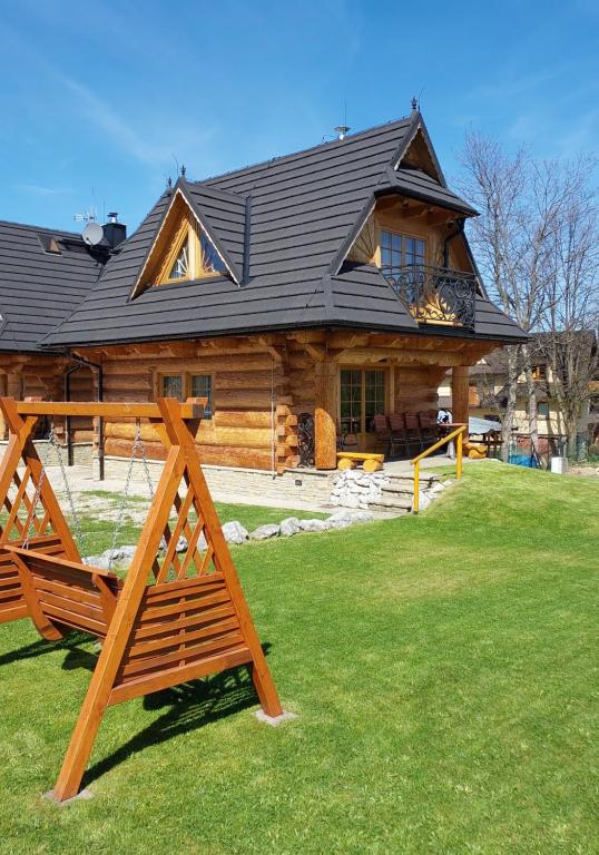 a log cabin with a bench in front of it at Smreco House in Zakopane