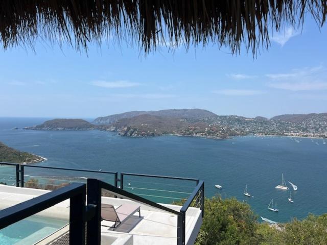 a view of a large body of water with boats at Welcome to the Jungle in Zihuatanejo