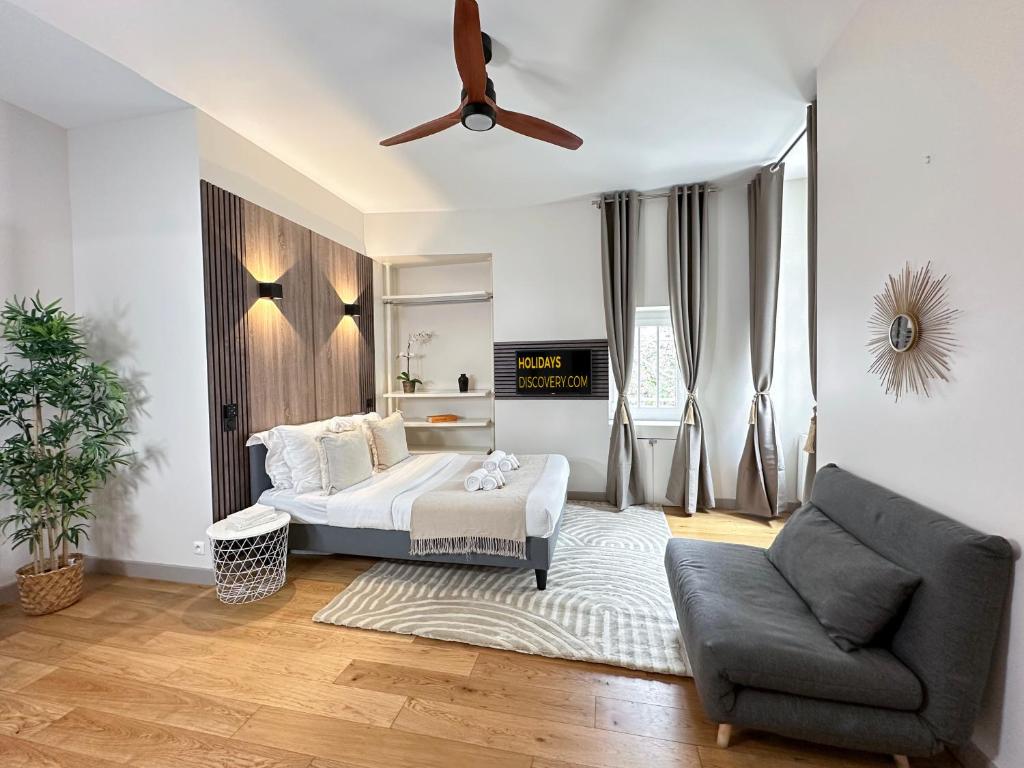 a bedroom with a bed and a ceiling fan at 2063 - Orsay studio in Paris Olympic Games 2024 in Paris