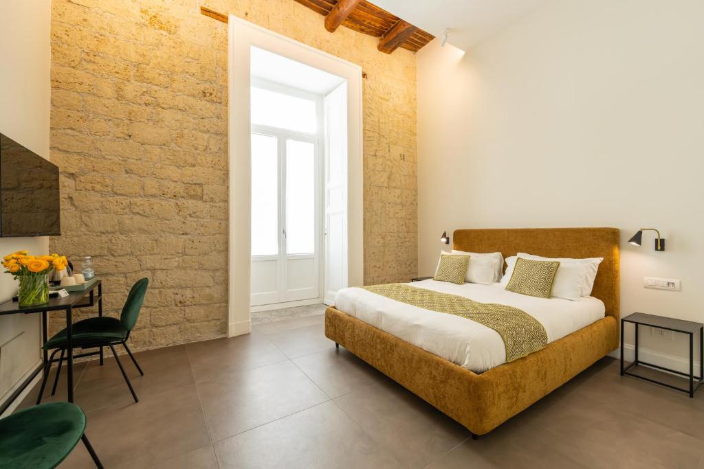 Schlafzimmer mit einem Bett, einem Tisch und einem Fenster in der Unterkunft Pignasuite in Neapel