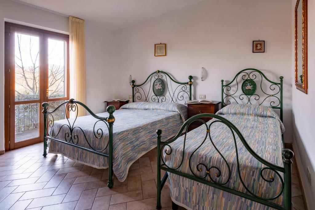Posteľ alebo postele v izbe v ubytovaní Relais Parco Del Subasio