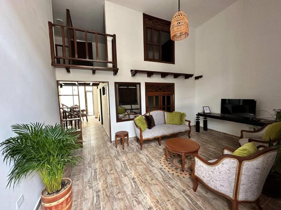 a living room with a couch and a table at Casa Aparicio in Buga