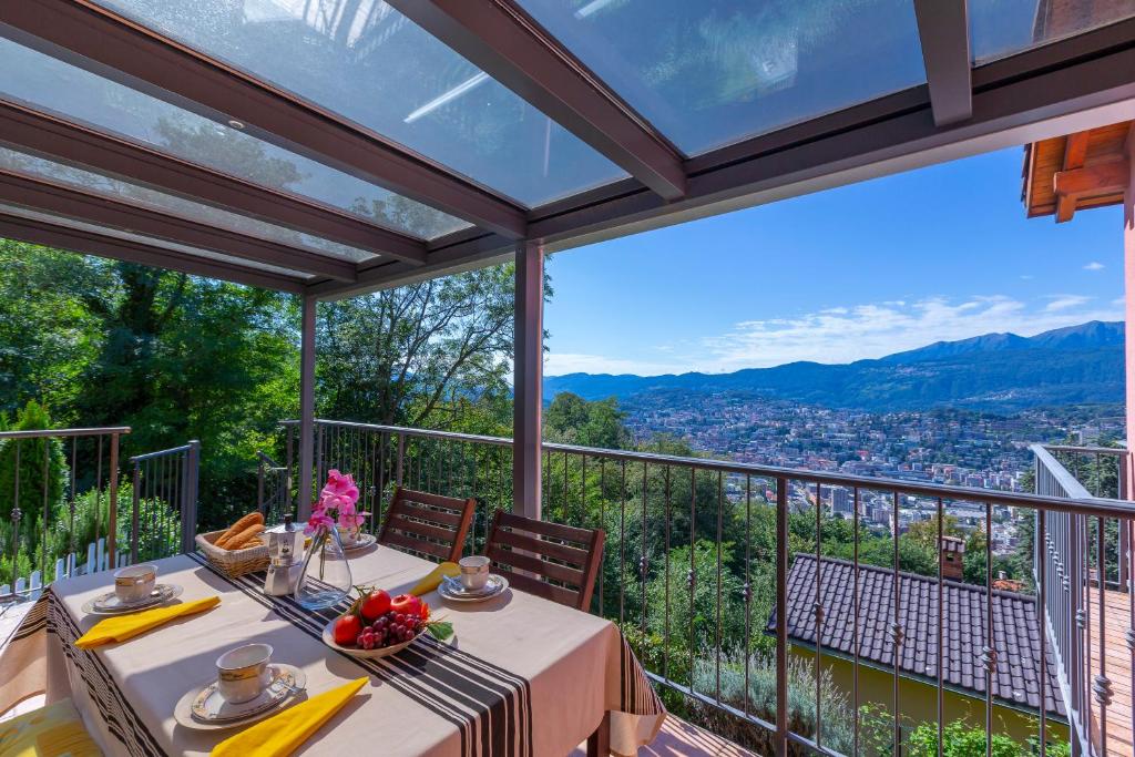 einen Esstisch auf einem Balkon mit Aussicht in der Unterkunft Viganello Panoramica in Viganello