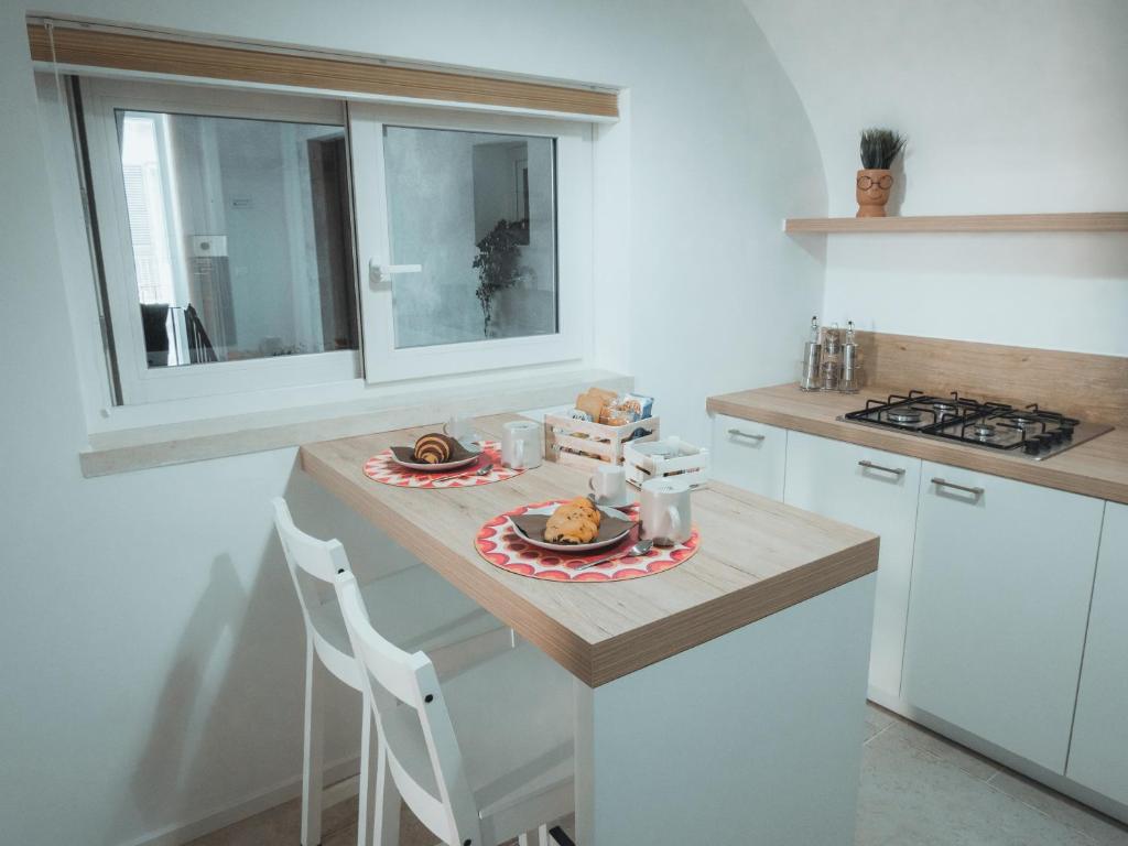 a kitchen with a table with a plate of food on it at C'era una Volta Apartments in Bisceglie