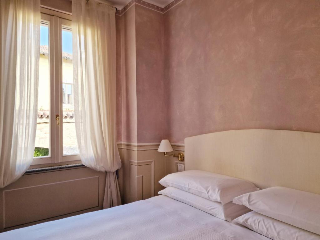 Postel nebo postele na pokoji v ubytování Relais Vimercati
