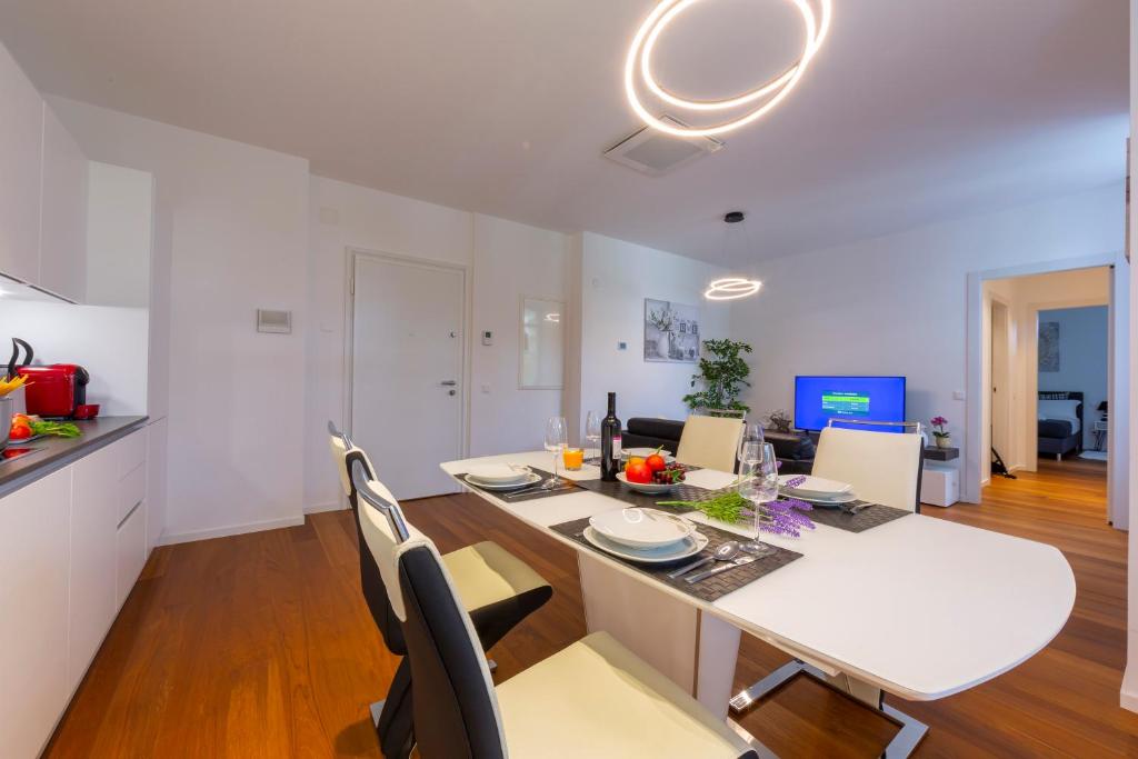 a kitchen and dining room with a white table and chairs at Love of Lugano - Happy Rentals in Lugano