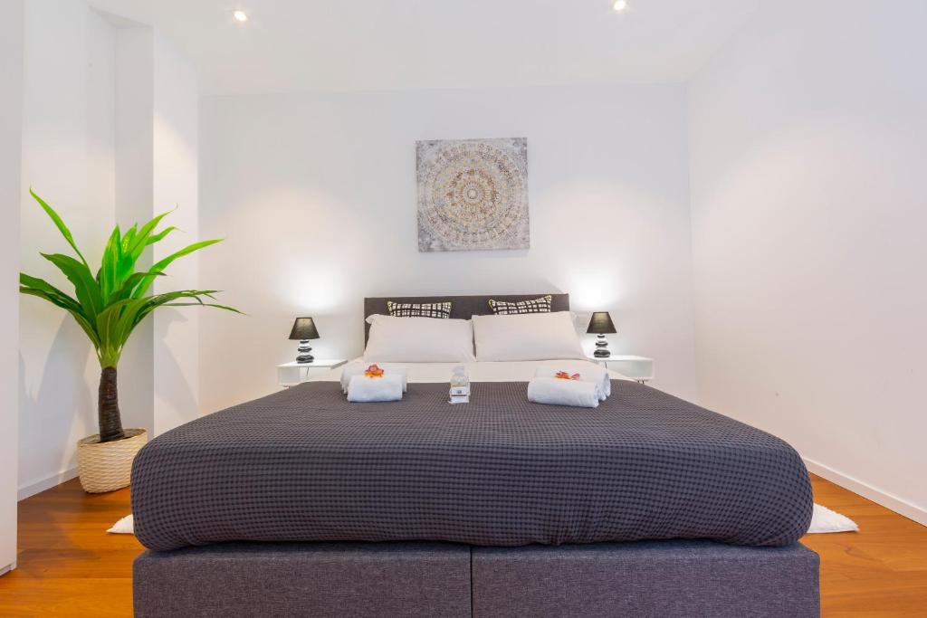 a bedroom with a large bed with two pillows at Love of Lugano - Happy Rentals in Lugano