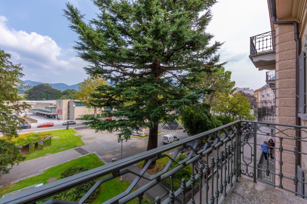 a balcony with a tree on a city street at Love of Lugano - Happy Rentals in Lugano