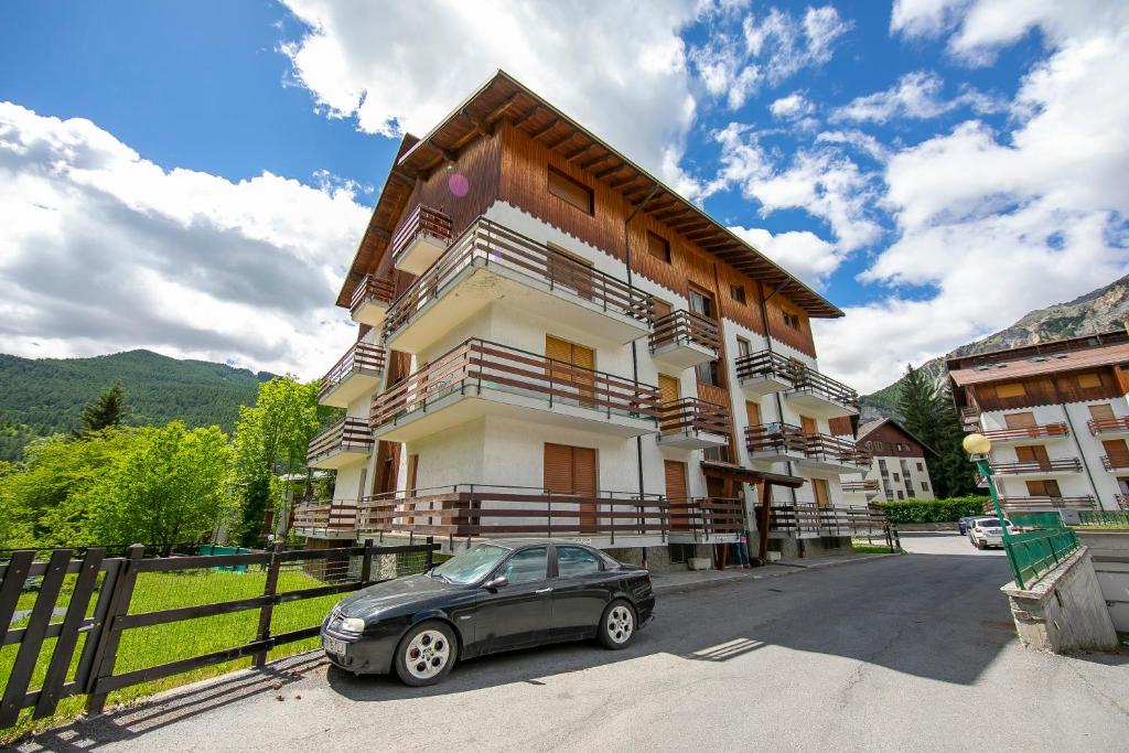 a car parked in front of a building at Bramé La Fam 32 few steps from skiing - Happy Rentals in Bardonecchia