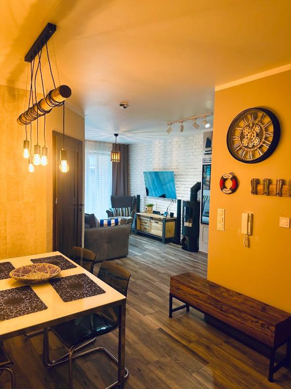 a living room with a table and a couch at Latarnia Morska in Jantar