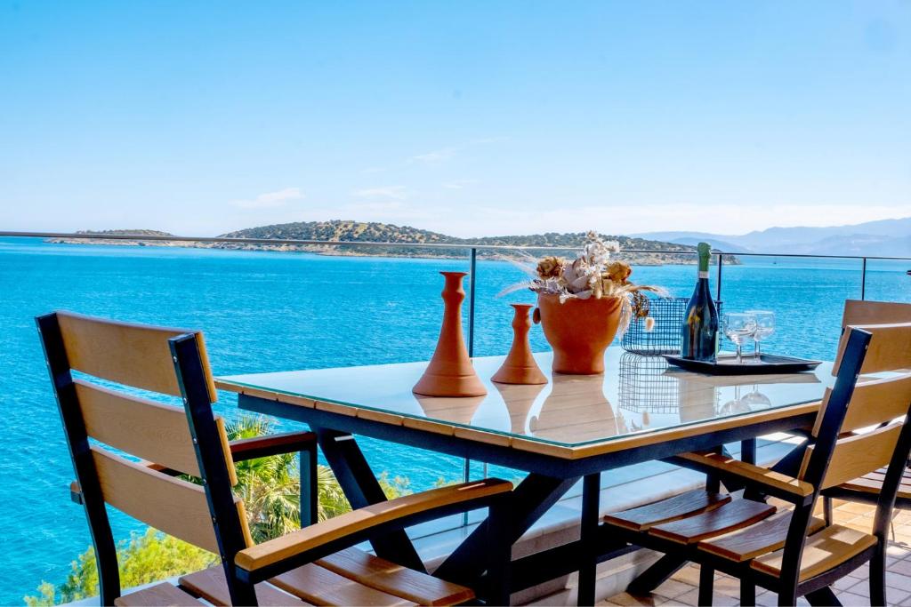 アギオス・ニコラオスにあるParadise seafront apartmentの海の景色を望む花瓶付きテーブル