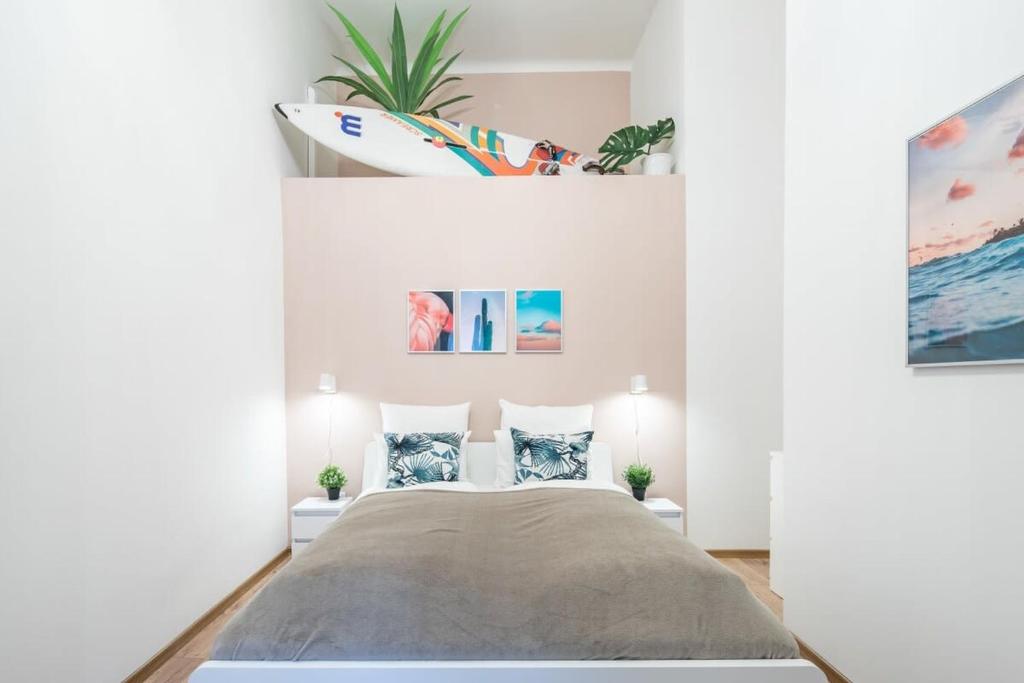 a bedroom with a bed and a surfboard on the wall at Full comfort, 4 bedrooms in the heart of the city in Budapest