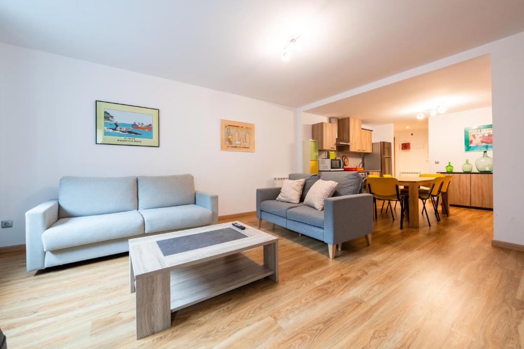 a living room with a couch and a table at Apartamento TINTIN en Arinsal in Arinsal