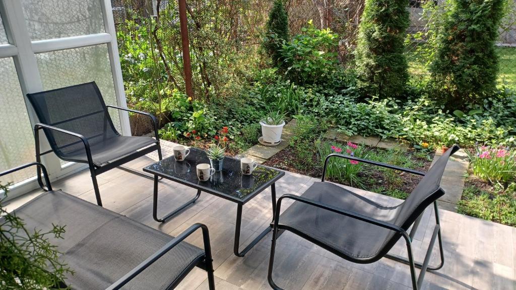 two chairs and a table on a patio at City Center Apartment with a Backyard in Burgas City