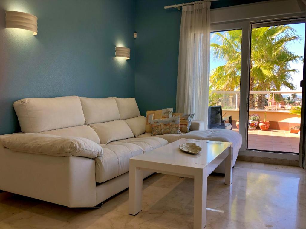 a living room with a white couch and a table at BRISA DEL MAR - 200m to the beach in Oliva
