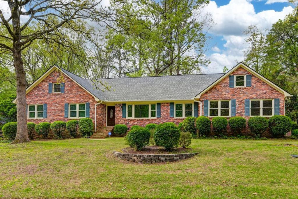 a brick house with a gray roof at The Quails Nest of Harbison in Columbia