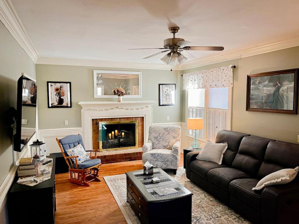 a living room with a couch and a fireplace at Serenity in the Suburbs in Columbia