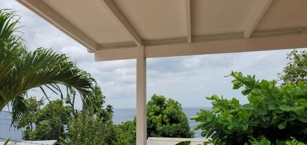 a view of the ocean from the porch of a house at Faith & Peace Guest House in Fontenoy