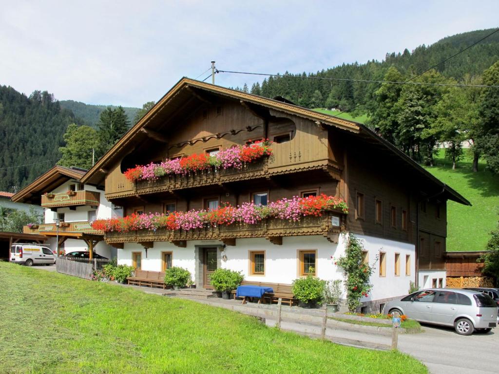 a building with flowers on the side of it at Apartment Schusterhäusl - MHO756 by Interhome in Schwendau