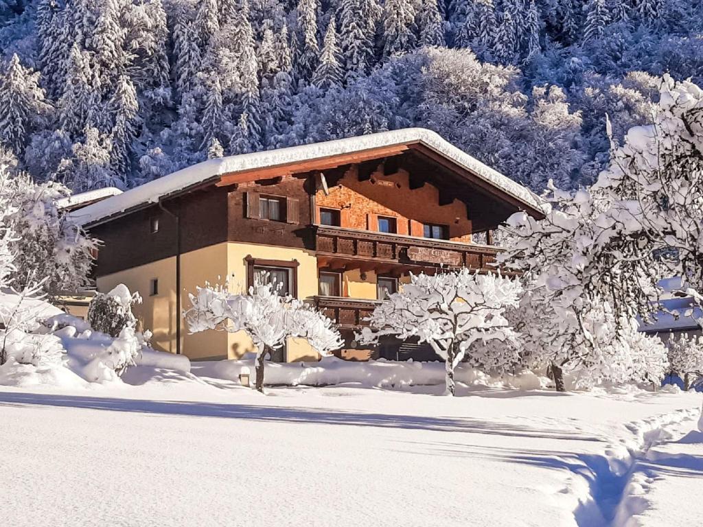 una baita di tronchi nella neve con alberi di Apartment Haus Corinna - GOP230 by Interhome a Sankt Gallenkirch