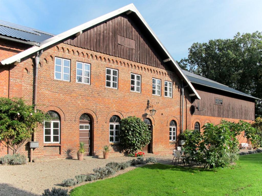 a large red brick building with a large roof at Holiday Home Gut Hörne-1 by Interhome in Hörne