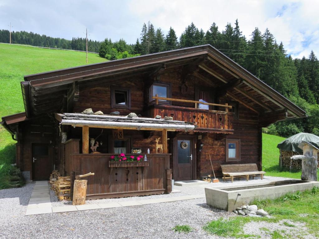 a log cabin with a porch and a balcony at Chalet Simonhütte - MHO640 by Interhome in Hippach